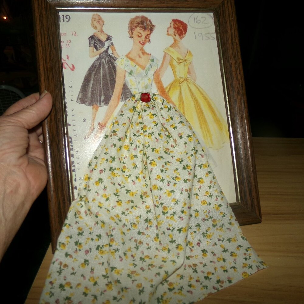 wood frame with photo and a cloth dress.